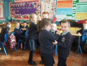 Children from P3/4 learning to Irish Dance 