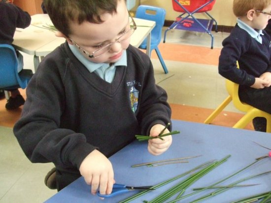 Ruairi making st brigids cros